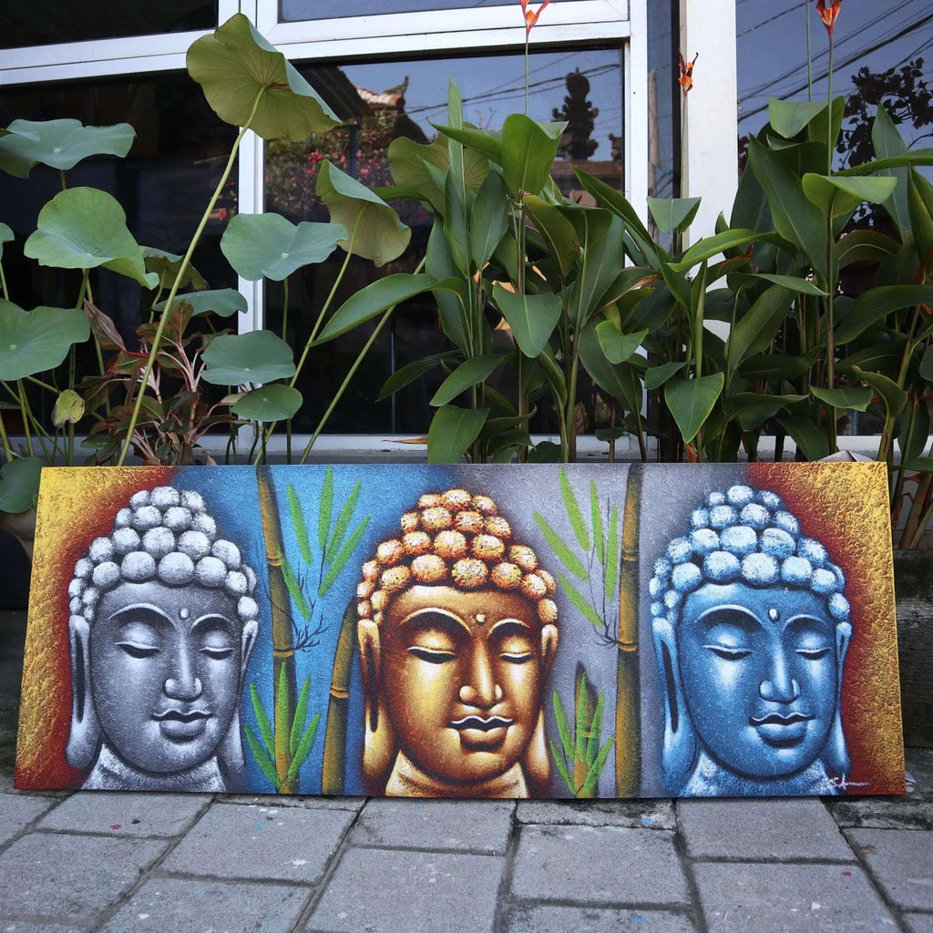 Buddha Painting - Three Heads With Bamboo featuring three stylized Buddha faces in silver, gold, and blue tones with bamboo stalks, set against a vibrant gradient background.