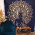 Double Cotton Bedspread + Wall Hanging - Buddha - Blue Gold featuring a detailed golden Buddha design with intricate mandala patterns on a deep blue background, displayed behind a teal chair and wooden table.