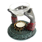 Antique Buddha - Offering Hands Oil Burner featuring hand-carved hands holding a glass bowl atop a textured base with a tealight candle holder, perfect for calming Buddha decor.