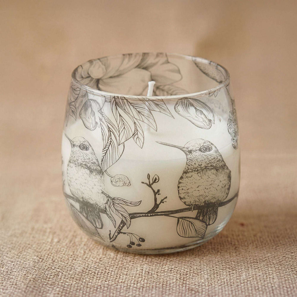Medium Glass Jar Candles - Drawn by Flame featuring a delicate black and white illustration of two birds perched on a branch, surrounded by leaves and floral elements.