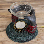 Antique Buddha - Offering Hands Oil Burner featuring detailed hands holding a glass dish above a tealight candle holder on an intricately textured base.