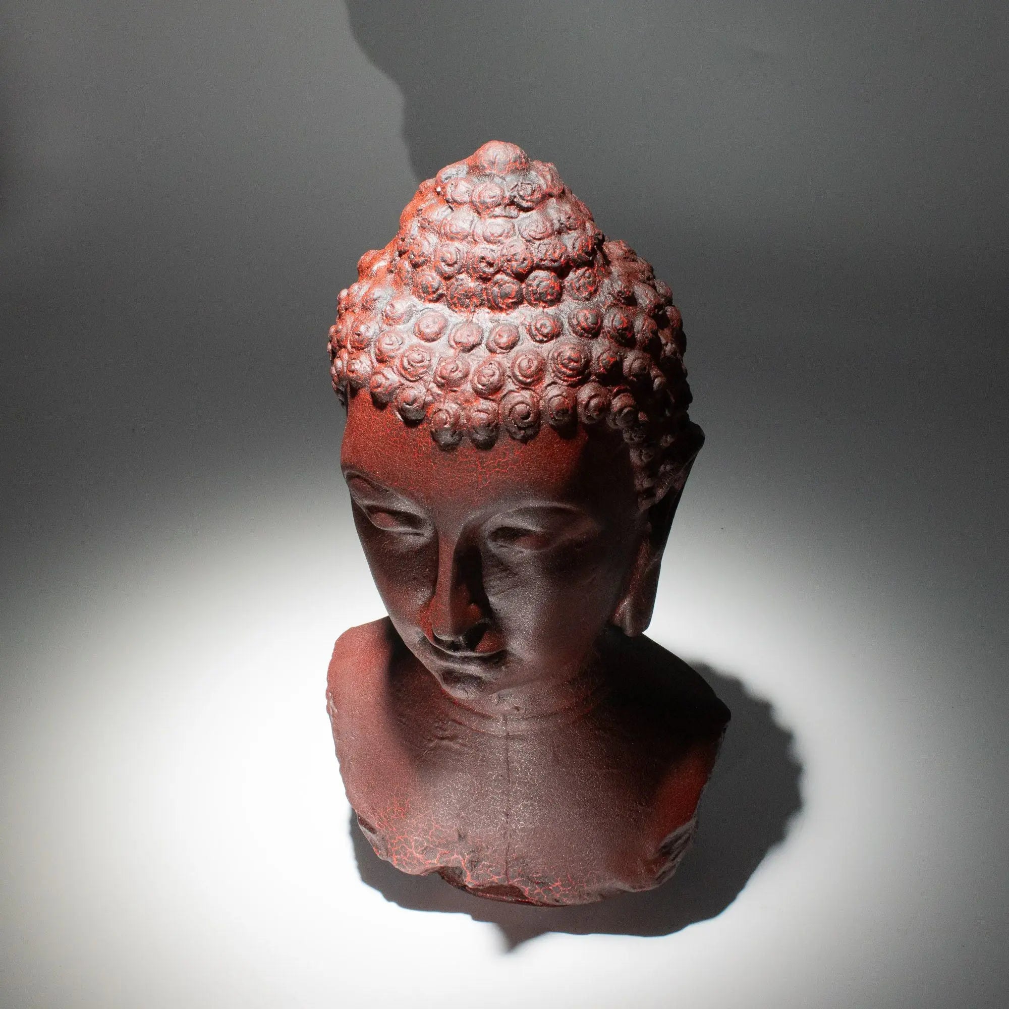 Buddha Bust Lamp Molton Lava - Oval stand featuring a hand-carved style Buddha head statue with textured curls, made of resin with a warm lava-like finish, softly illuminated.