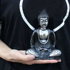 Person holding a Black & Grey Buddha - Medium statue in a seated meditation pose, showcasing intricate details and a serene expression.