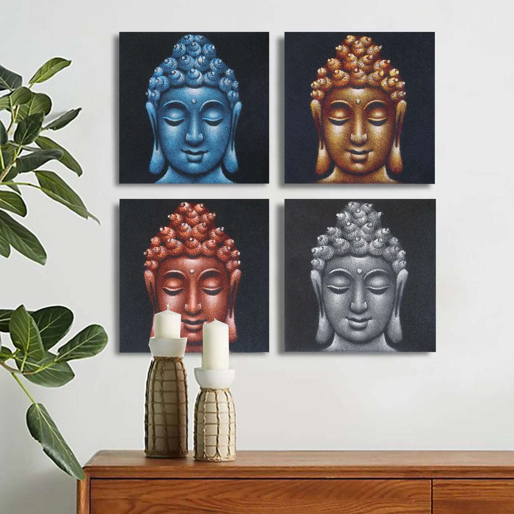 Set of 4 Buddha Heads Sand Detail 40x40cm wall hangings featuring four serene Buddha faces in blue, gold, red, and silver tones above a wooden sideboard with candles and a plant.
