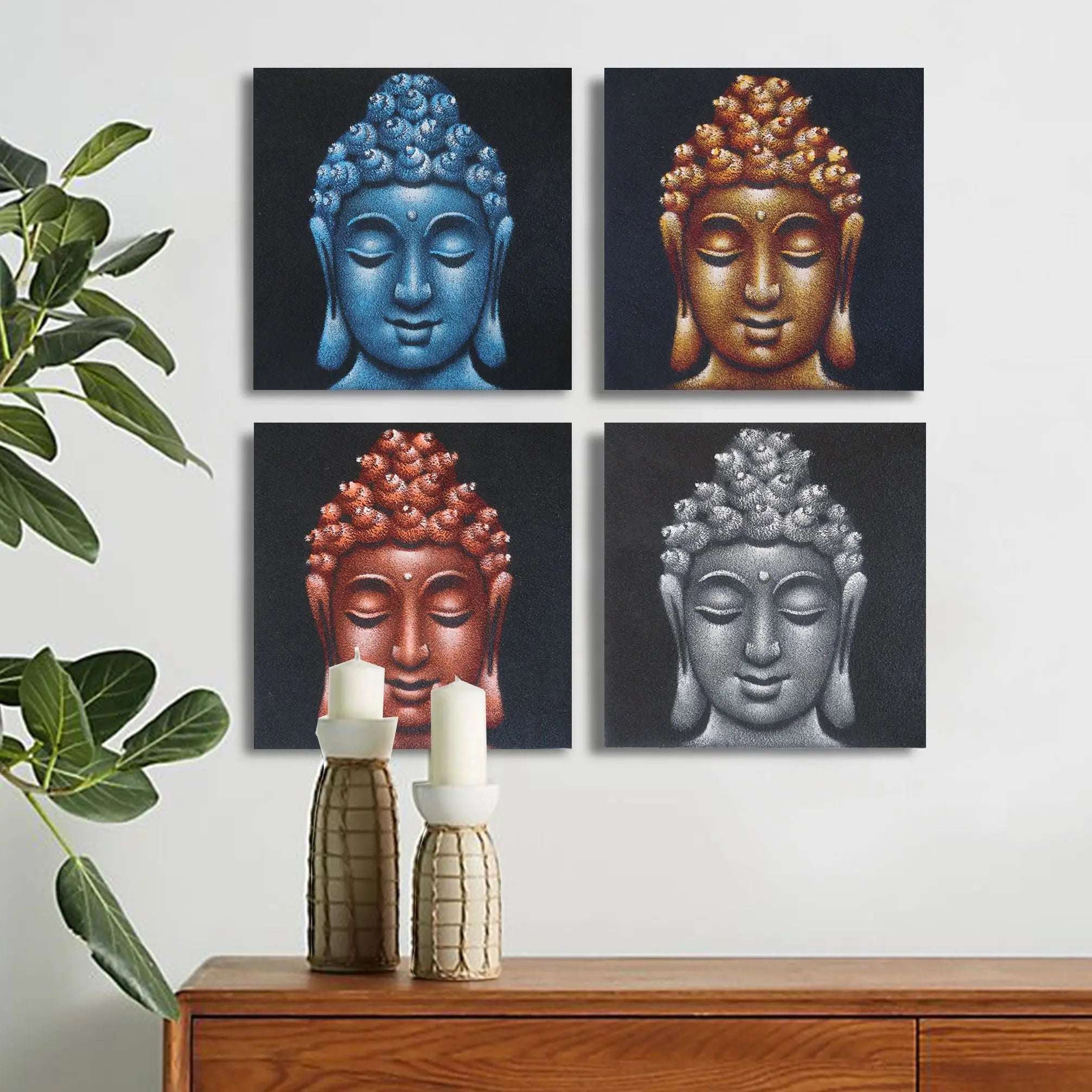 Set of 4 Buddha Heads Sand Detail 40x40cm wall hangings featuring four serene Buddha faces in blue, gold, red, and silver tones above a wooden sideboard with candles and a plant.