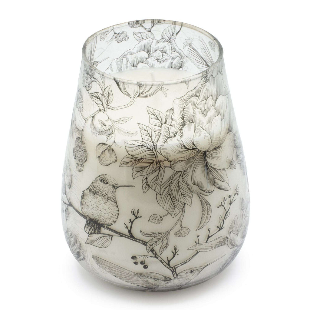 Tall Glass Jar Candles - Drawn by Flame featuring a delicate black and white botanical and hummingbird design on a tapered glass jar with a white candle inside.