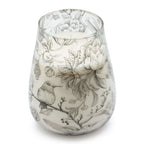 Tall Glass Jar Candles - Drawn by Flame featuring a delicate black and white botanical and hummingbird design on a tapered glass jar with a white candle inside.