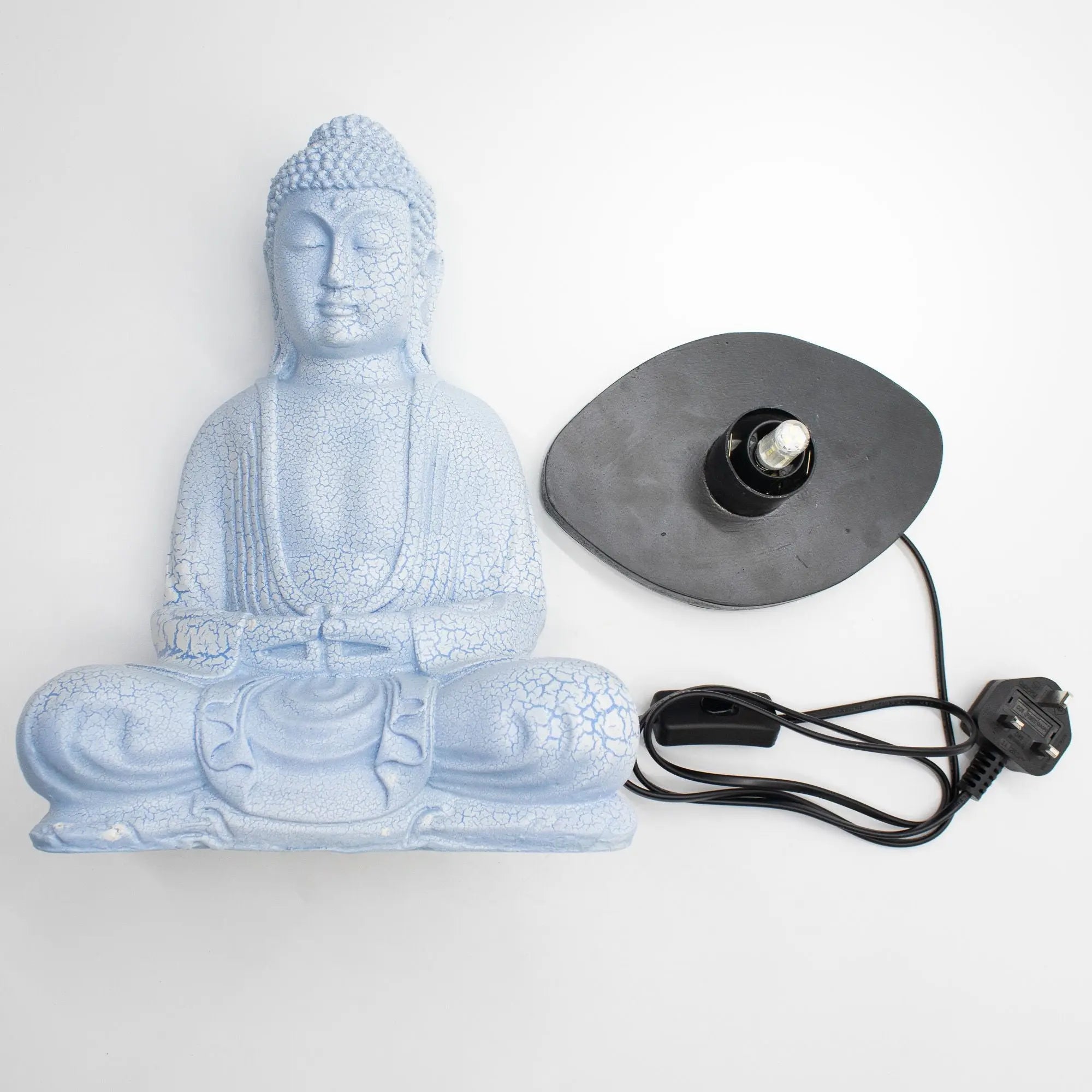 Meditation Buddha Lamp Sky Blue - Oval Stand features a serene sky blue resin Buddha statue with a crackle finish, paired with a black oval lamp base and cord for peaceful decor.