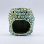 Ceramic Buddha Oil Burner - Blue with textured surface resembling Buddha head, designed for gently warming essential oils and enhancing calming atmosphere.