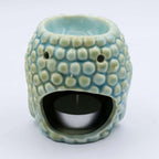 Buddha Oil Burner - Blue with textured surface designed for holding a tealight candle and essential oils, creating a calming ambiance for meditation or home decor.
