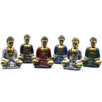 Six Gold Mini Buddha (Assorted Colours) statues in various painted robes sitting in meditation pose, displayed on a white background as resin Buddha decor pieces.