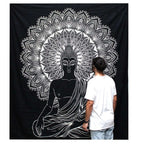 A person stands in front of a large black and white wall hanging featuring a detailed Buddha design with an intricate mandala pattern, showcasing the B&W Double Cotton Bedspread + Wall Hanging - Buddha.