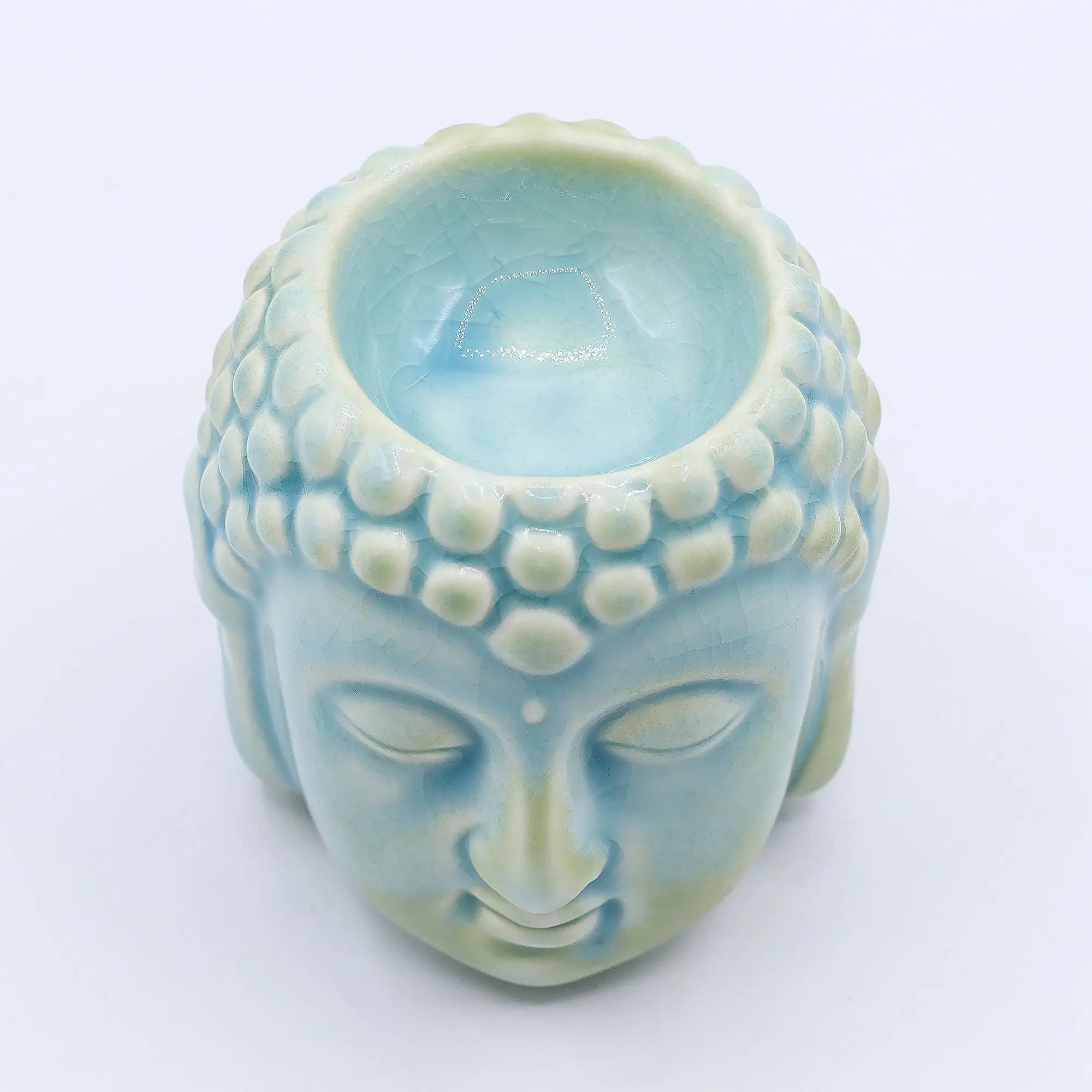 Buddha Oil Burner - Blue featuring a serene Buddha head design in soft blue ceramic, perfect for creating a calming atmosphere with essential oils or wax melts.