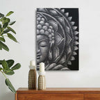 Grey Half Buddha Mandala 60x80cm featuring a serene Buddha face with intricate mandala patterns in shades of grey, displayed above a wooden surface with decorative candles and greenery.