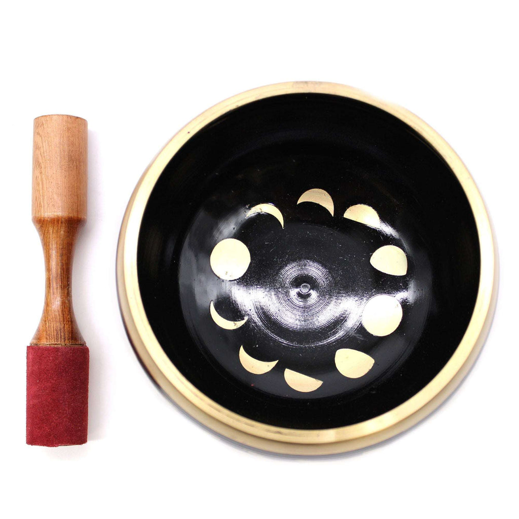 Large Moon Phase Singing Bowl Set- Black 14cm with gold moon phase designs inside and a wooden mallet with a red suede tip placed next to it on a white background.