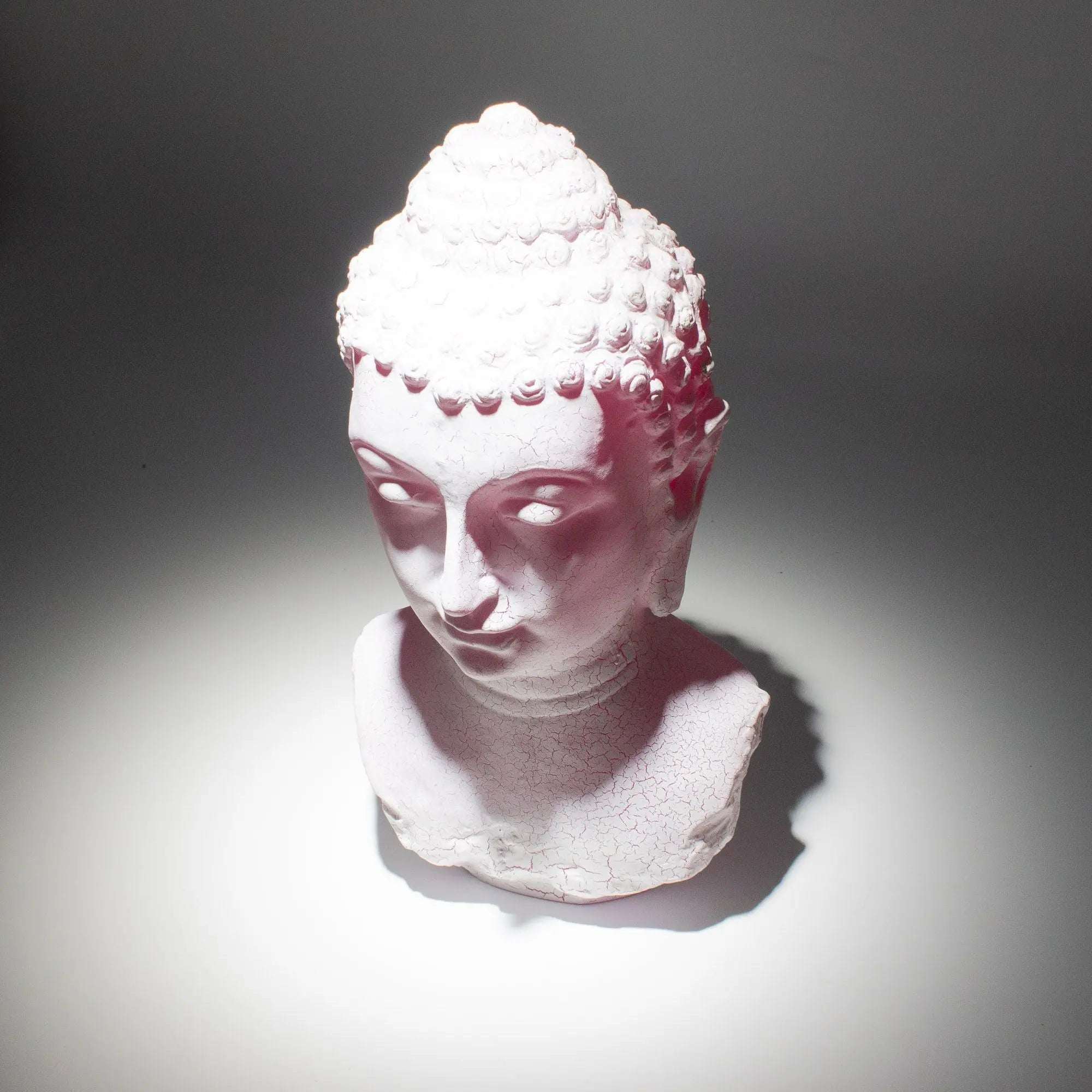 White Buddha Bust Lamp Cherry Crackle - Oval stand casting soft light with subtle cracks on textured surface, evoking calm and peaceful Buddha decor ambiance.