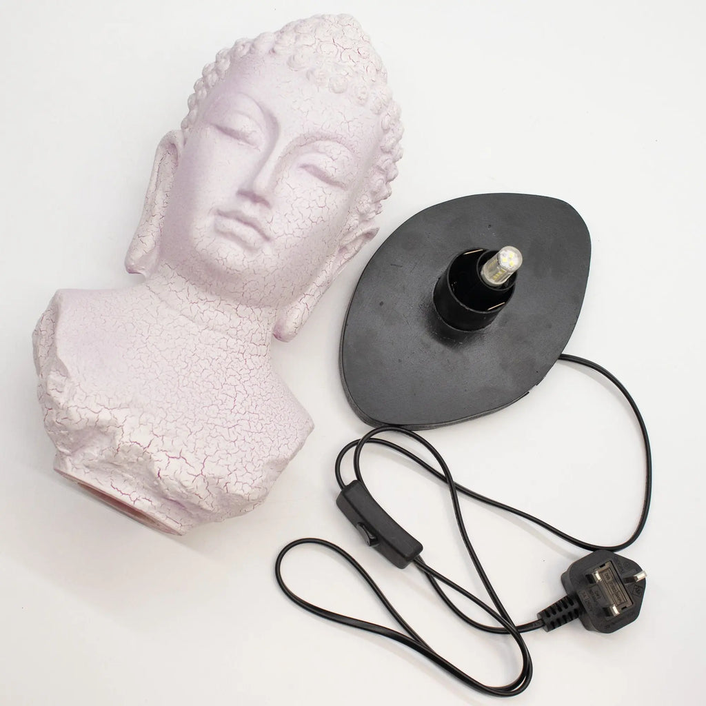Buddha Bust Lamp Cherry Crackle - Oval stand featuring a pale cherry crackle finish Buddha head bust next to an oval black lamp base with a power cord and switch.