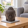 Buddha Head Oil Burner - Dark Brown on a stone mat in a British sitting room