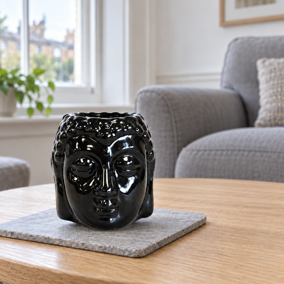 Buddha Oil Burner - Black on a stone mat in a British sitting room