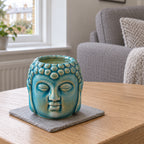 Buddha Oil Burner - Blue on a stone mat in a British sitting room