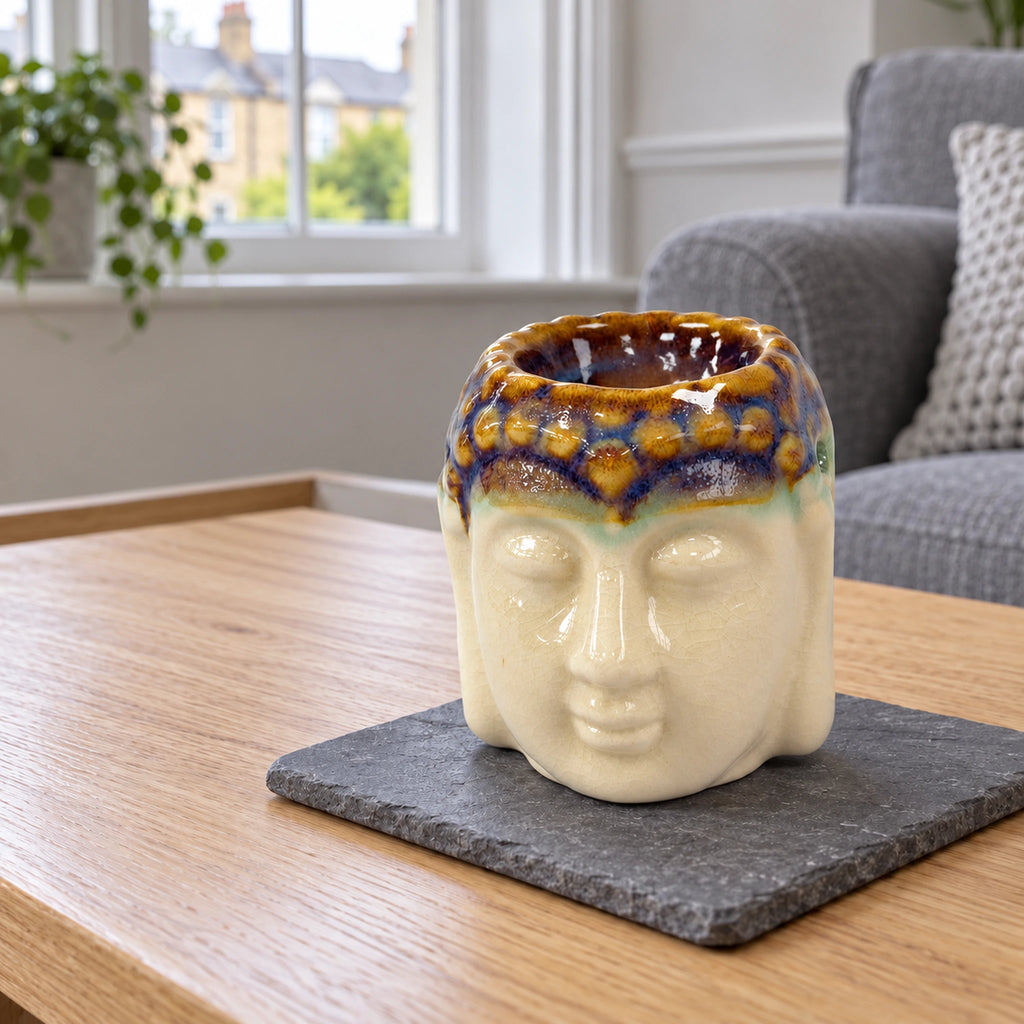 Buddha Oil Burner - Ivory & Mint on a stone mat in a British sitting room