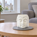 Buddha Oil Burner - White on a stone mat in a British sitting room