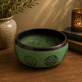 Earth Powder Singing Bowl - Mandala Buddha - 16cm with intricate mandala designs and Buddha imagery, placed on a wooden surface next to a candle and ceramic vase.