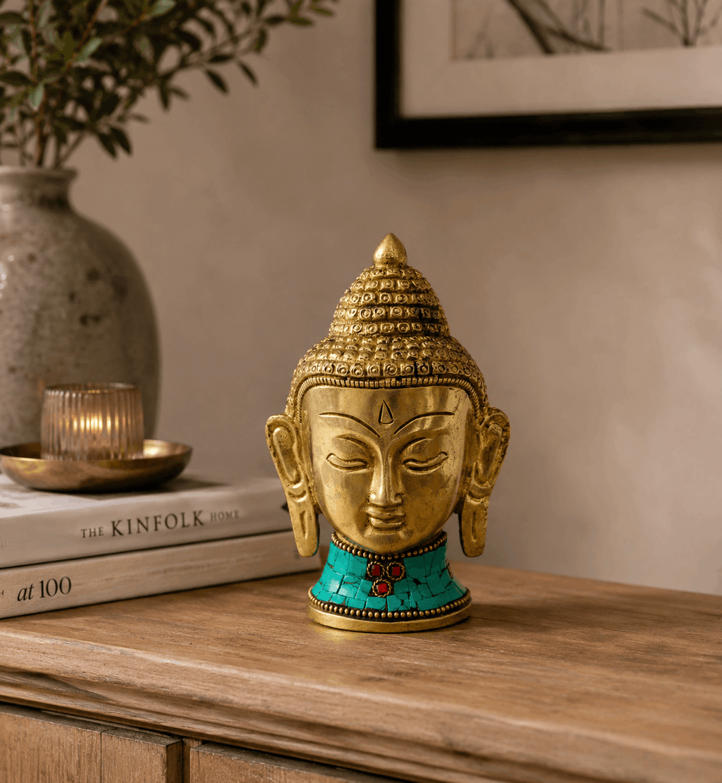 Brass Buddha Figure - Lrg Head - 11.5 cm with intricate detailing and turquoise inlay, displayed on a wooden surface with a calm, minimalist background.