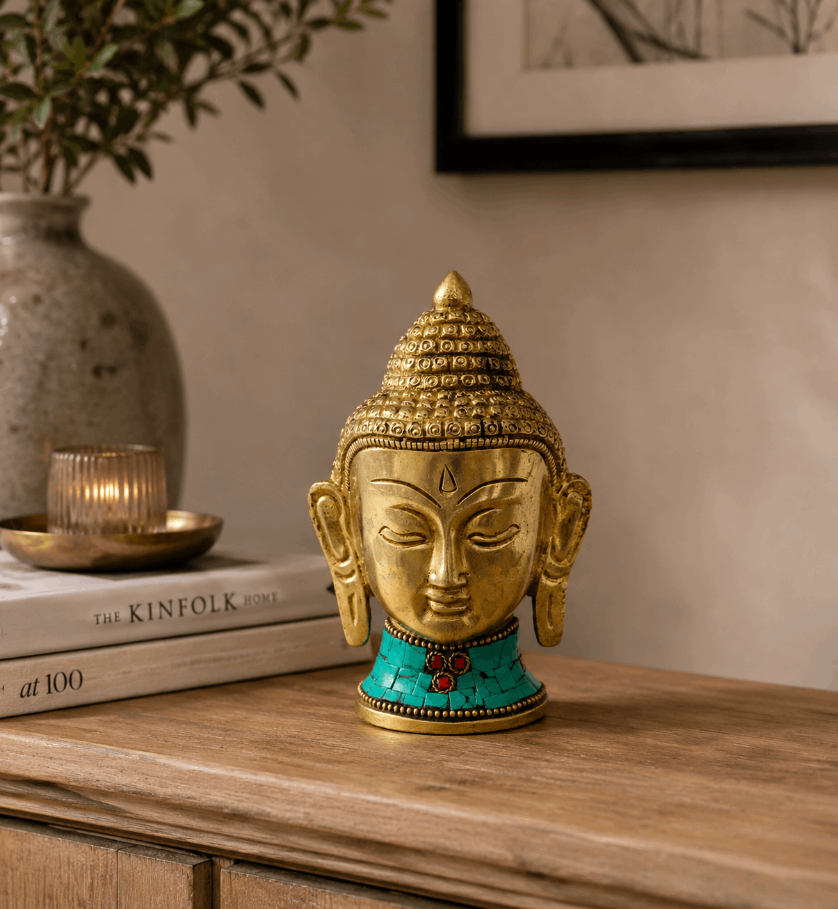 Brass Buddha Figure - Lrg Head - 11.5 cm with intricate detailing and turquoise inlay, displayed on a wooden surface with a calm, minimalist background.