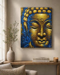 Buddha Painting - Gold Face & Lotus Flower featuring a textured close-up of a serene Buddha face with golden and deep blue accents, displayed on a neutral wall above wooden furniture.