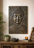 Large Buddha Iron Frame Antique Gold Relief - 0.7x1m wall hanging depicting a serene Buddha face surrounded by embossed leaves, displayed above a wooden console with decor accents.