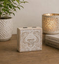 Small Square Box 10x10x4.2cm - Buddha Face Whitewash featuring a whitewashed carved Buddha face design, styled with a decorative planter and candle holder on a wooden surface.