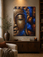 Buddha Painting - Copper Face featuring a textured, abstract close-up of a serene Buddha face in copper tones with blue and orange accents, displayed in a cozy living room setting.