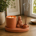 Multi Purpose Buddha Incense Plate - Natural Terracotta Style featuring a terracotta Buddha statue, incense holder with burning sticks, and a lit candle on a matching plate.