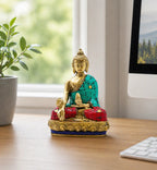 Brass Buddha Figure - Hands Down - 11.5 cm seated on a wooden desk, featuring intricate turquoise and red inlay, symbolizing calm and meditation in a serene office setting.