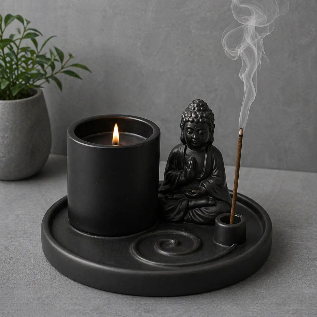 Multi Purpose Buddha Incense Plate - Ceramic Matt Black holding a lit candle and a burning incense stick beside a seated Buddha figure on the circular tray.