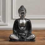 Black & Grey Buddha - Medium statue in a seated meditation pose, featuring detailed textured hair and flowing robes, made of resin with an aged black and grey finish.