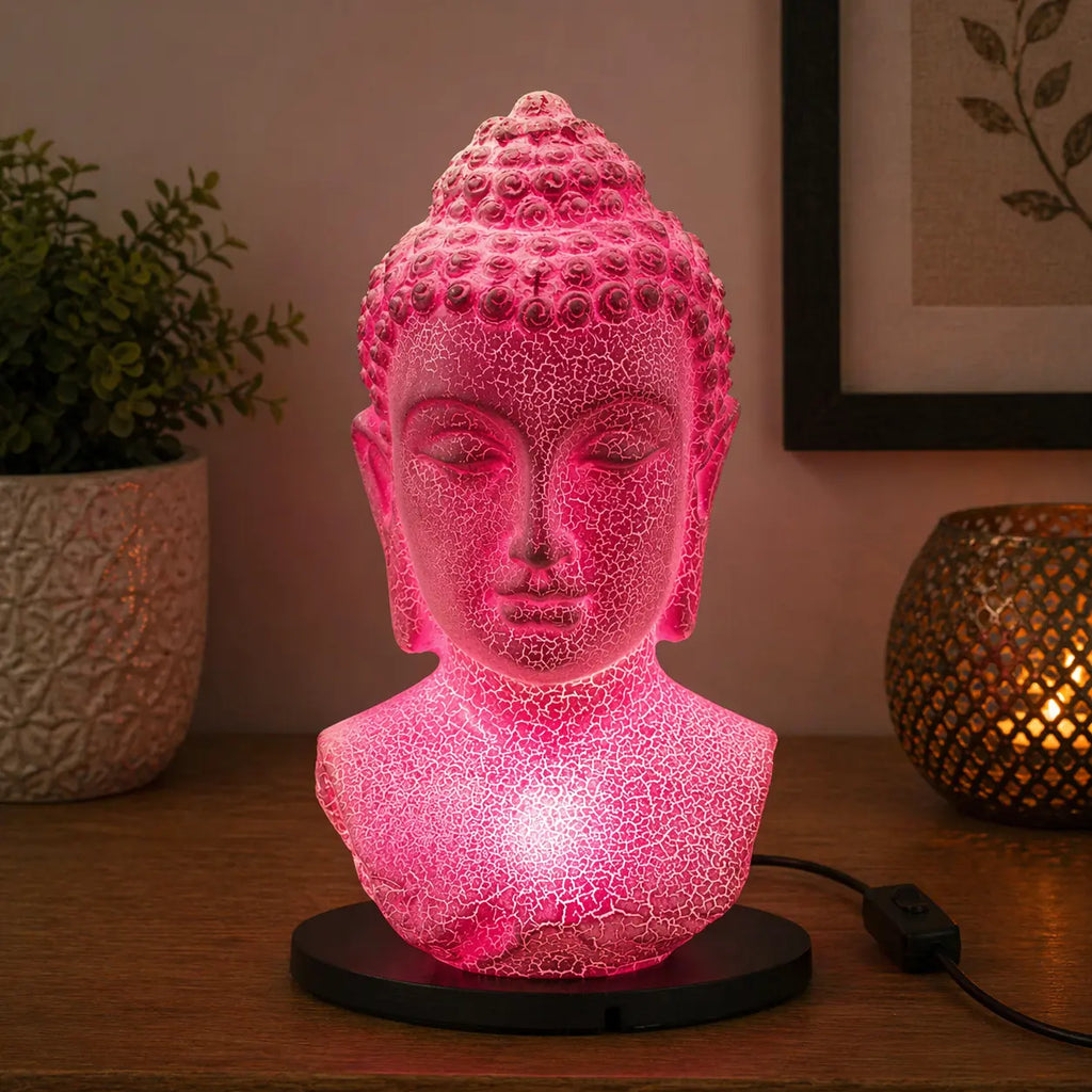Buddha Bust Lamp Cherry Crackle - Oval stand glowing with soft pink light on a wooden surface, featuring a crackled texture and calm Buddha face design.