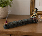 Antique Buddha - Incense Burner & Box featuring a gold and black seated Buddha figure with intricate carvings, holding a lit incense cone with smoke drifting upward.