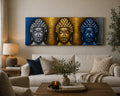 Buddha Painting - Three Heads Gold Detail featuring three serene Buddha faces in silver, gold, and blue tones, displayed above a cozy living room sofa with neutral decor.