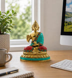Brass Buddha Figure - Blessing - 15cm seated on a desk, featuring intricate turquoise and red inlay, ideal for peaceful home or office decor and spiritual inspiration.