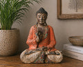 Vintage Orange Hand Carved Buddha Statue - 40cm - Teaching Transmission seated on a wooden surface, with intricate detailing and a serene expression, styled as Buddha decor in a cozy interior setting.