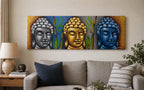 Buddha Painting - Three Heads With Bamboo featuring three serene Buddha faces in silver, gold, and blue tones with green bamboo accents, displayed above a modern living room sofa.