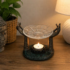 Antique Buddha - Om Hands Oil Burner featuring hand-carved resin hands holding a decorative glass dish above a lit tea candle, ideal for calming Buddha-themed decor.