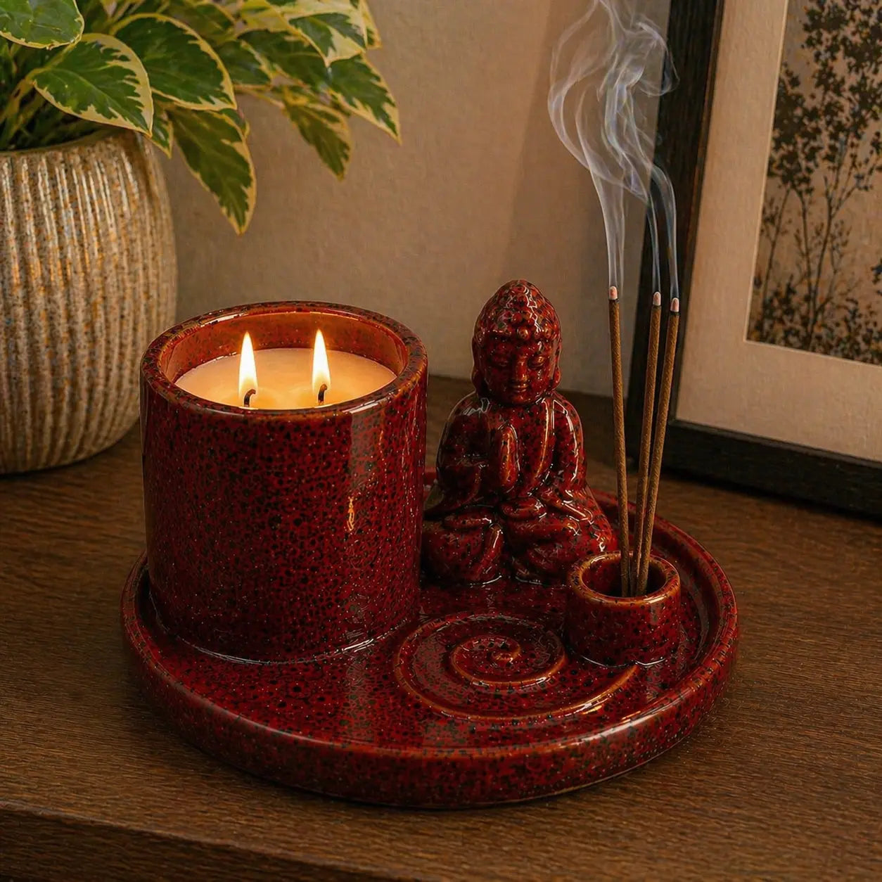 Multi Purpose Buddha Incense Plate - Ceramic Soft Red featuring a soft red ceramic Buddha statue, incense holder with burning incense sticks, and a two-wick candle on a round plate.