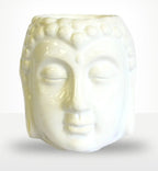 Buddha Oil Burner - White featuring a smooth, serene Buddha face design crafted from glossy white ceramic, perfect for creating a calming ambiance in any space.