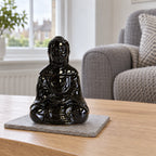 Sitting Buddha Oil Burner - Black on a stone mat in a British sitting room
