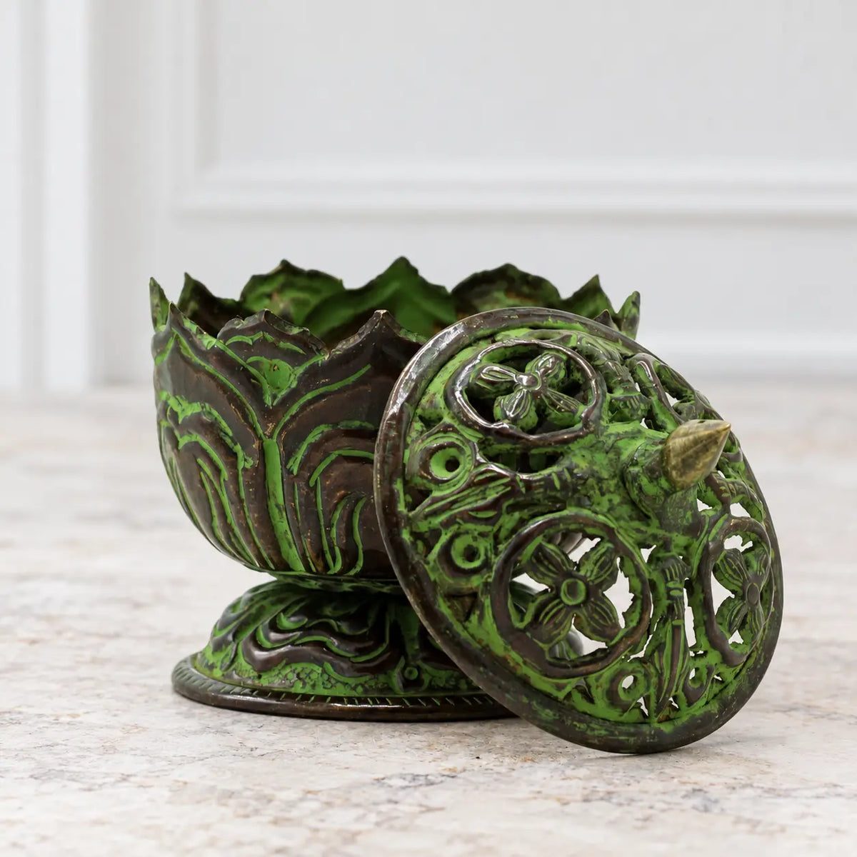 Small brass verdigris Tibetan lotus incense burner with the floral pierced lid removed, showing the open bowl.