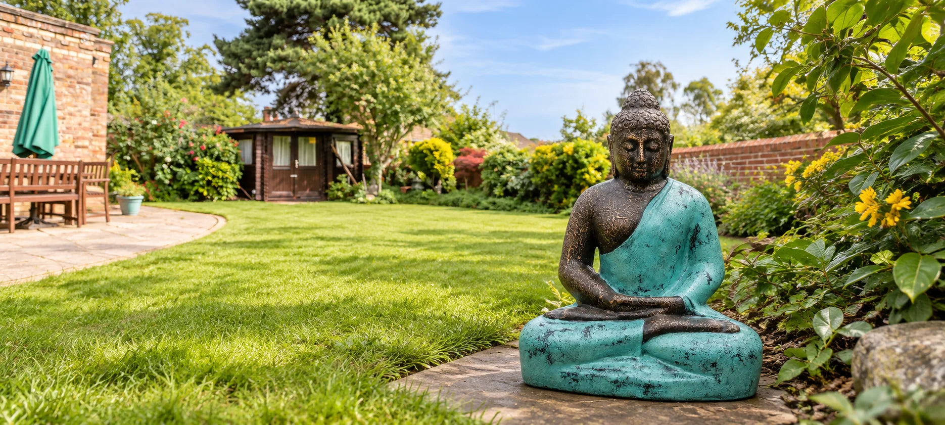 Turquoise garden Buddha in a British cottage garden