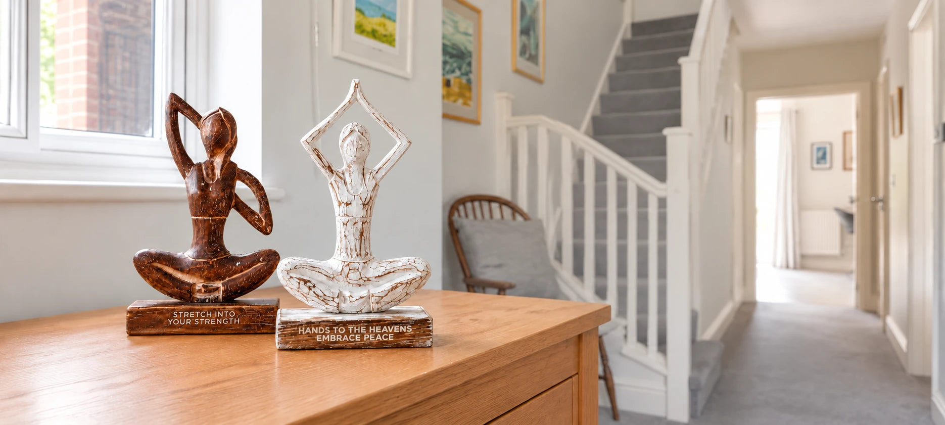Wooden yoga figurines on a cabinet in a British hallway
